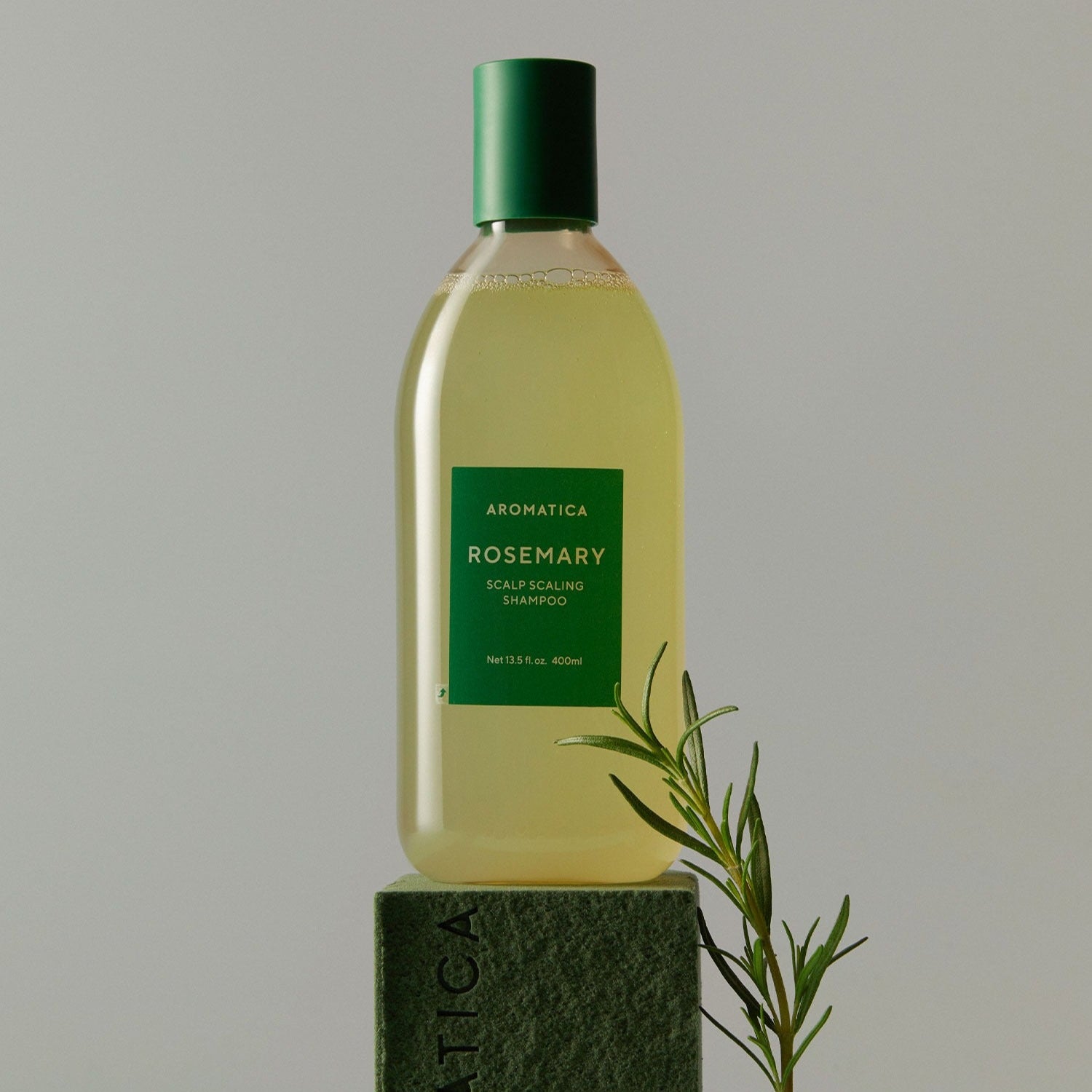 AROMATICA Rosemary Scalp Scaling Shampoo 750ML bottle with rosemary sprig on a studio background.