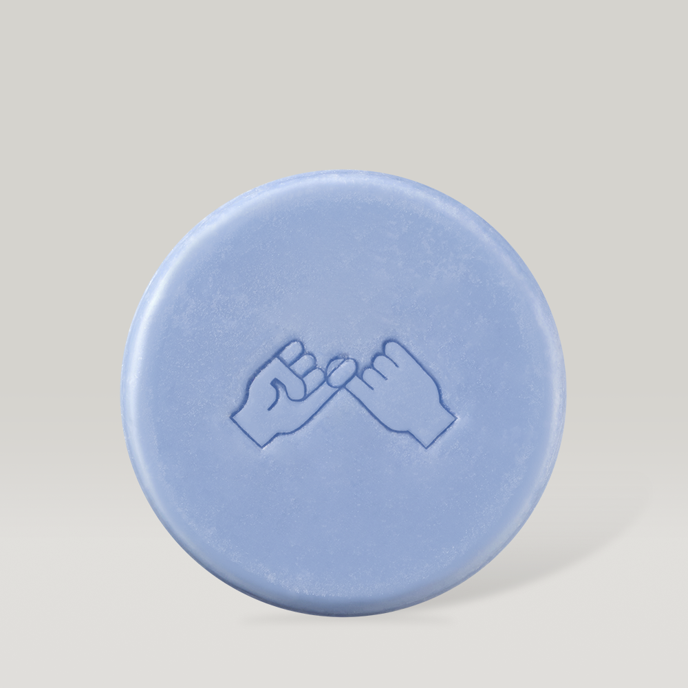 Blue DONGGUBAT Field Correct Rinse Bar with embossed design against a neutral background.
