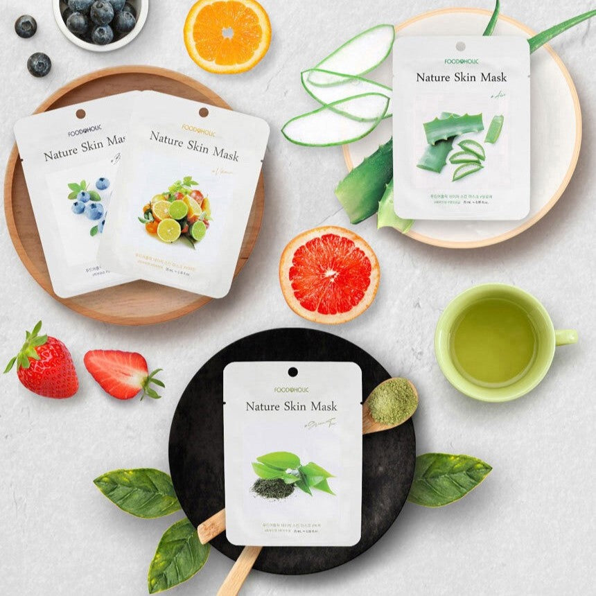 FOODAHOLIC Nature Skin Mask 1+1 with fresh natural ingredients displayed on a table