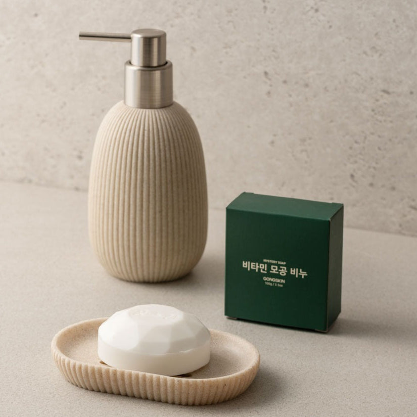 GONGSKIN Aloe Vitamin C Pore Soap 100g on a beige soap dish with dispenser