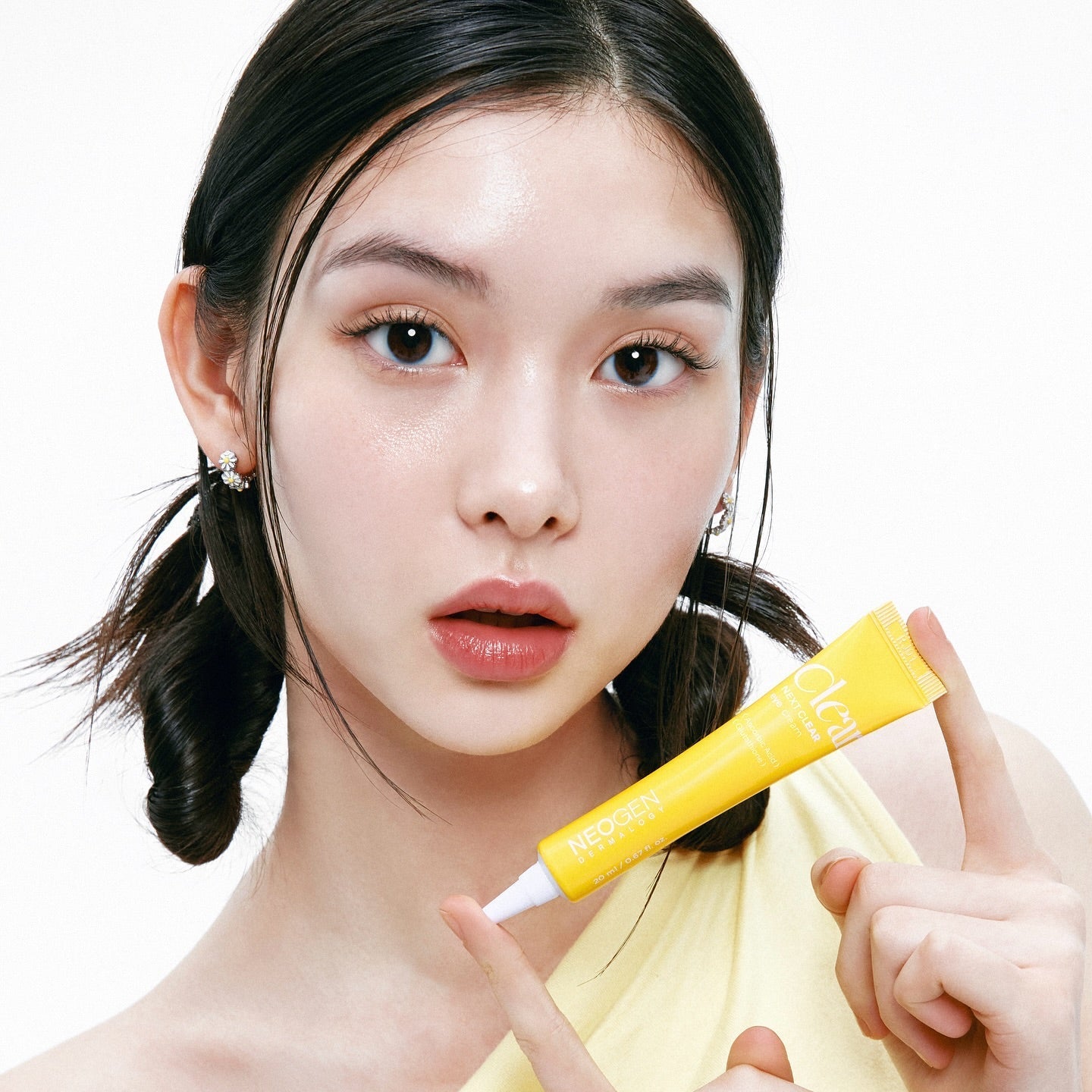 Person holding NEOGEN Next Clear Eye Cream 20ml tube, showcasing skincare product.