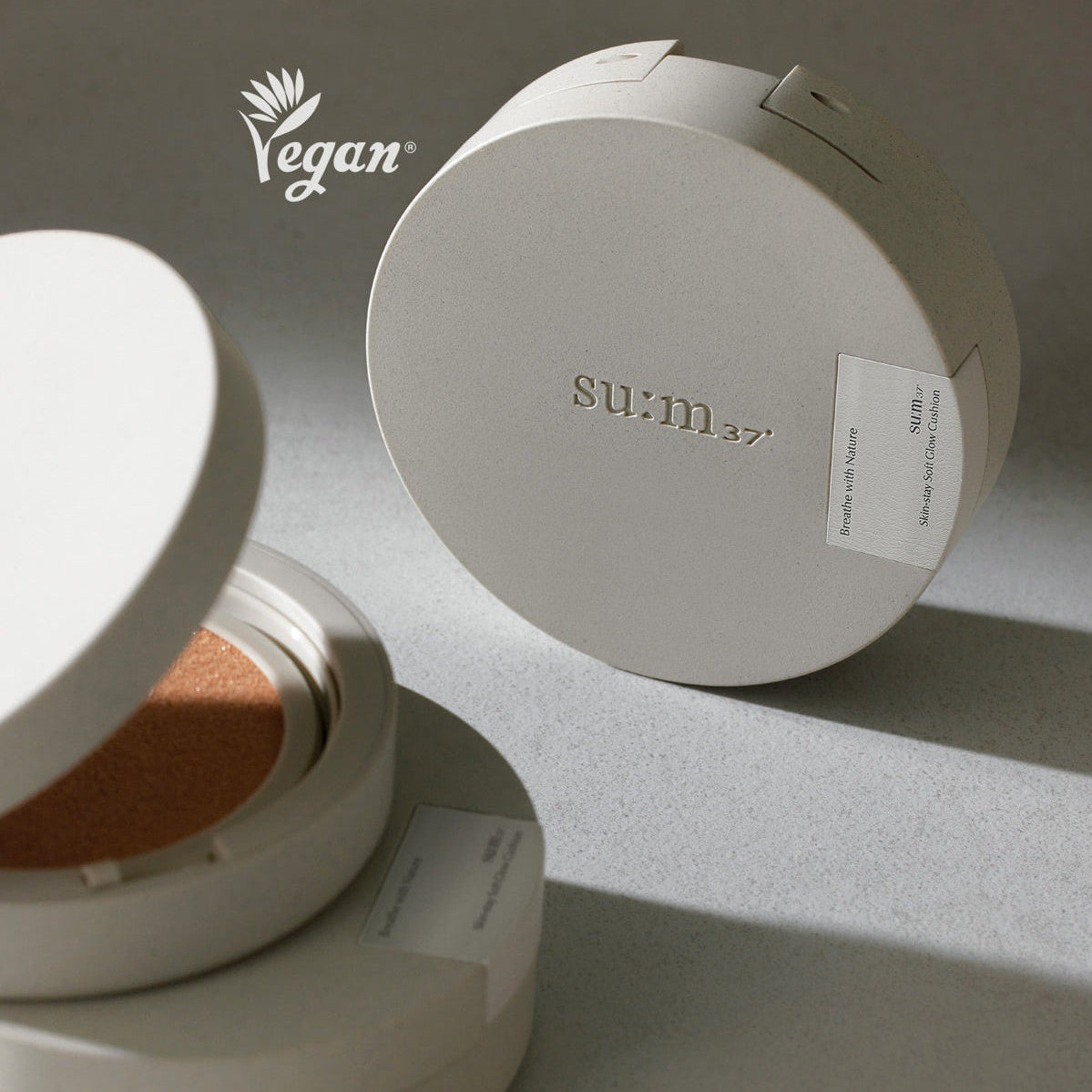 SU:M37 Skin-Stay Soft Glow Cushion compact with vegan logo, highlighting luxurious skincare and beauty product packaging.