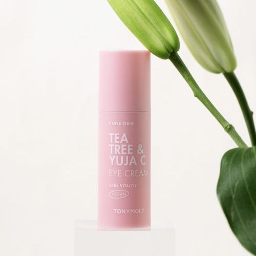 TONYMOLY Pure Dew Tea Tree & Yuzu Seed Vitality Eye Cream 30ml with floral backdrop, skincare product for vitality and hydration.