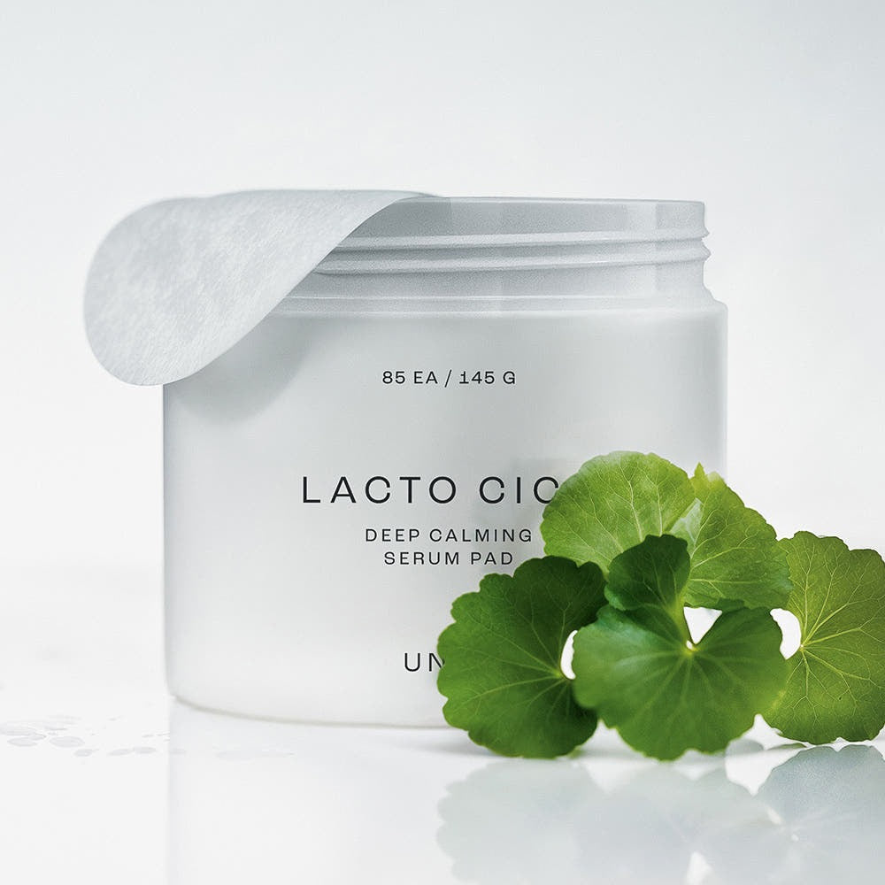 UNPA Lacto Cica Deep Calming Serum Pad 85 Sheets in white container with green leaves, skincare product for soothing skin.