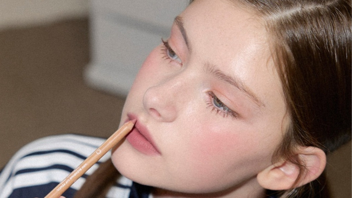 Achieve the perfect glowy lip with AOU's luscious lip products; woman applying AOU lip product for a radiant look.