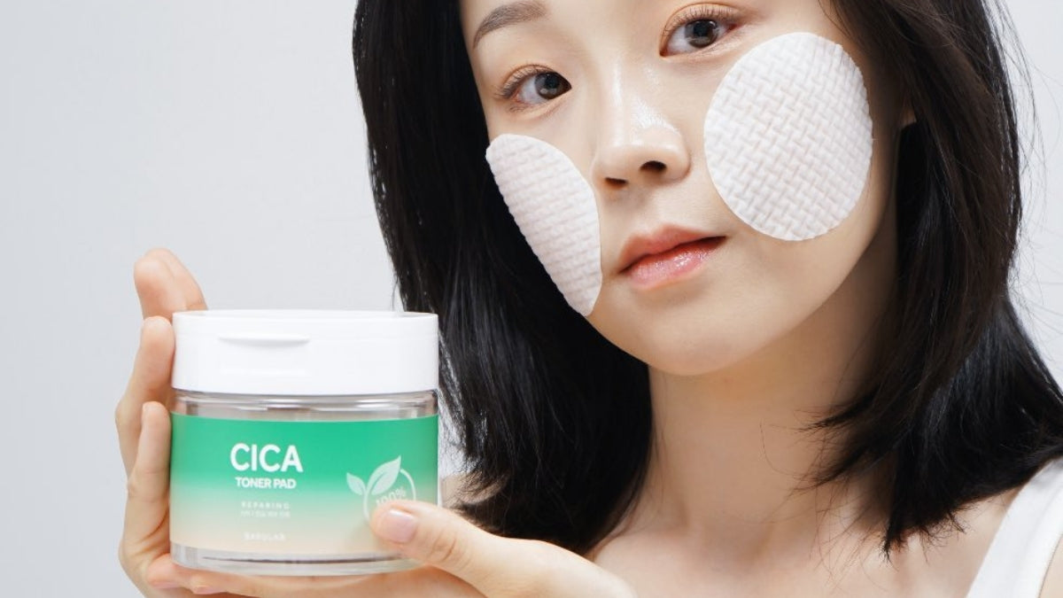 Woman using CICA pads for facial care, highlighting 'Elevate Your Skincare with BARULAB's Innovative Formulations:'