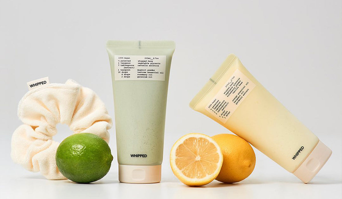 Discover WHIPPED: The Korean Brand Redefining Beauty and Skincare products with citrus and scrunchie backdrop.