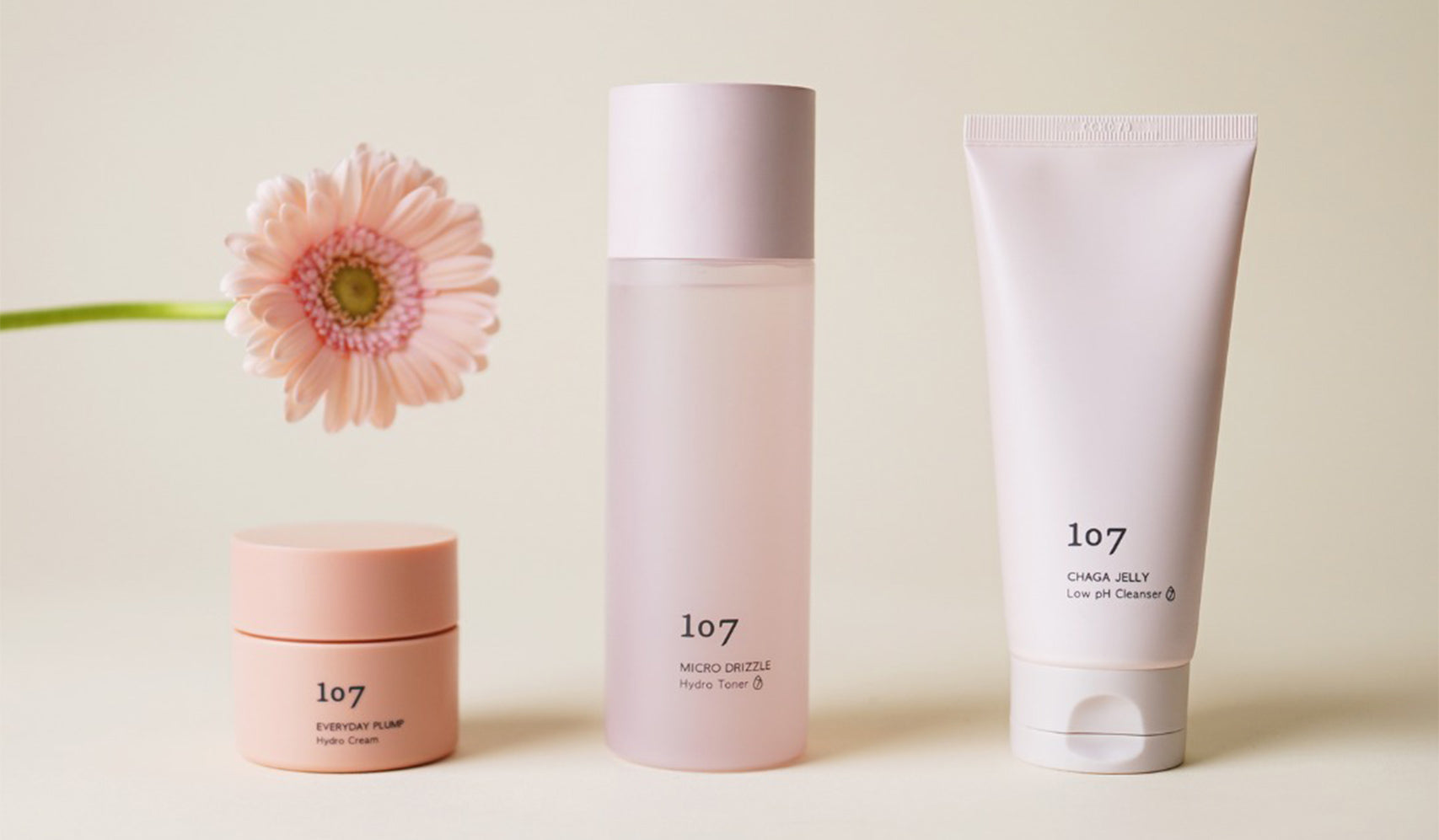 Skincare products bottle and tube with pink flower for a clean beauty routine