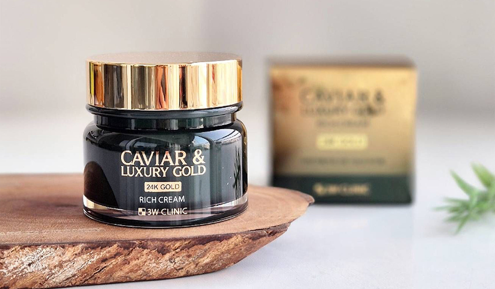 Luxury gold-infused caviar cream jar on wooden surface with box in background, skincare product