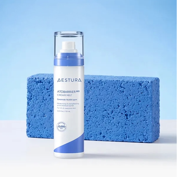 AESTURA Atobarrier 365 Cream Mist 120ml bottle displayed against a blue textured background.