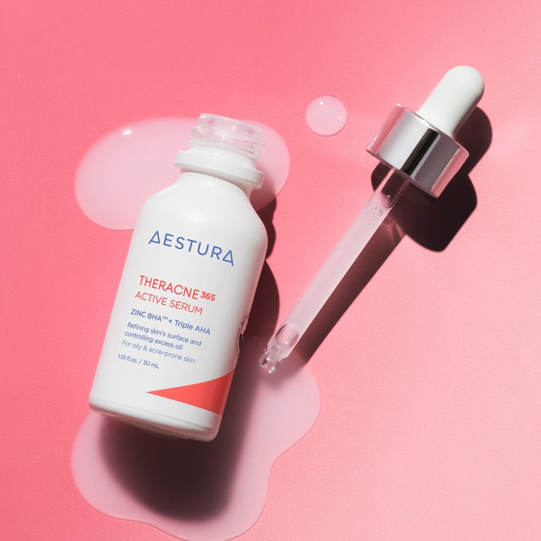 Bottle of AESTURA Theracne 365 Active Serum 30ml with dropper on pink background