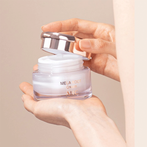 Person opening jar of AHC H Mela Root Cream 50ml