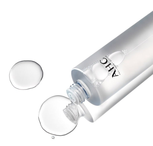 Bottle of AHC Prep Reset Micellar Cleansing Water 255ml with liquid droplets on white background
