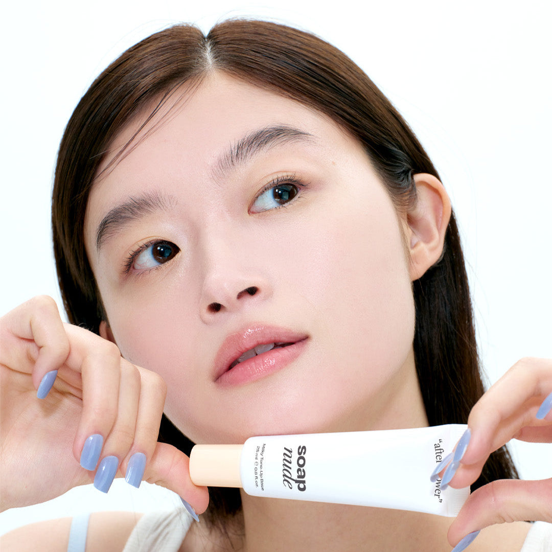 Person holding ALTERNATIVE STEREO Soap Nude Milky Tone-Up Base SPF30 PA++, showcasing product texture and packaging.