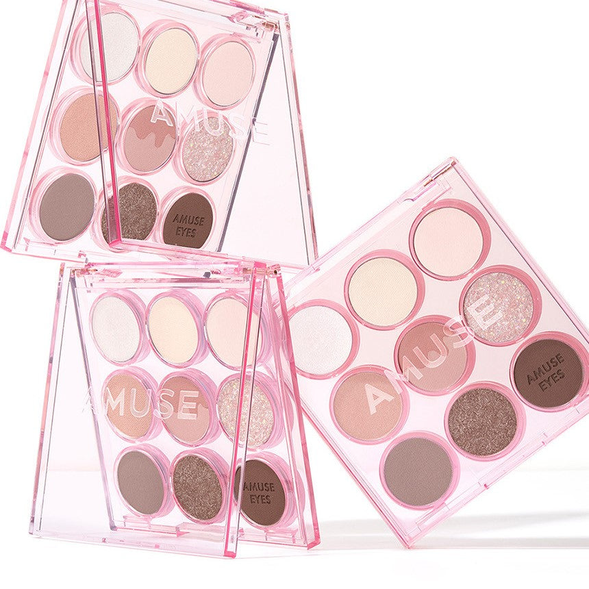 AMUSE Eye Color Palette featuring a variety of pink and neutral shades in a stylish pink case.