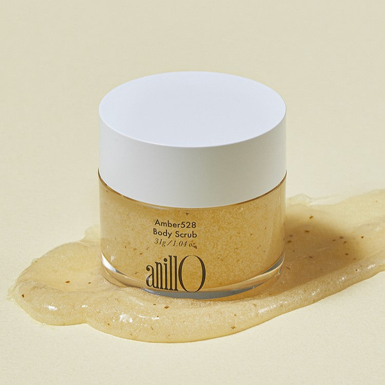 ANILLO Amber528 Body Scrub 31g jar on spilled scrub background