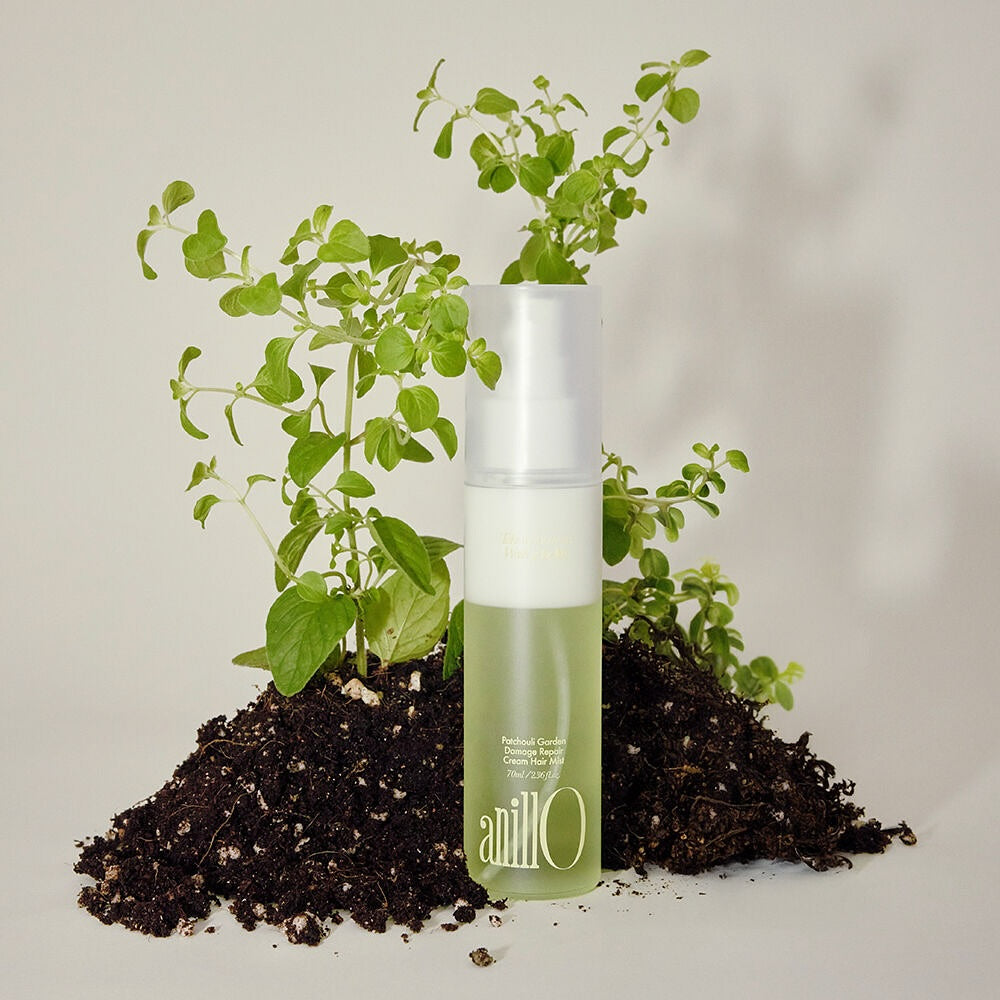 ANILLO Patchouli Garden Damage Repair Cream Hair Mist 70ml with natural ingredients displayed on soil and plants