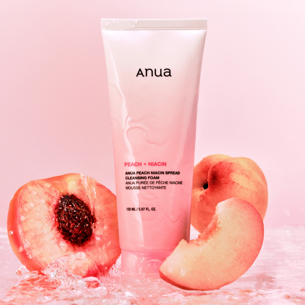 ANUA Peach Niacin Spread Cleansing Foam 150ml with fresh peaches in background