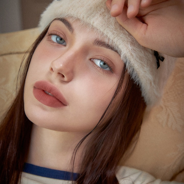 Woman wearing AOU Floofy Matte Balm showcasing smooth, matte lips and natural look.