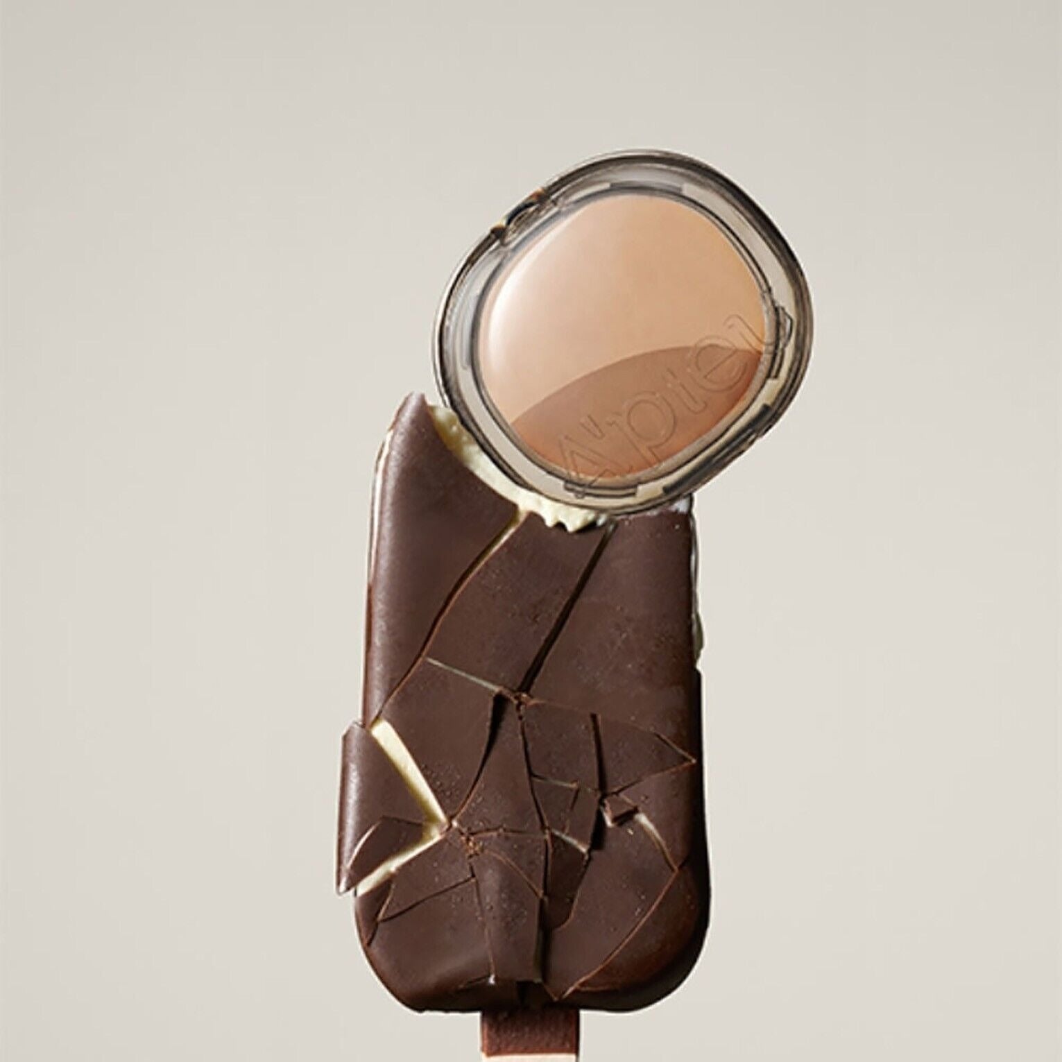 A'PIEU Juicy Pang Layering Shading next to chocolate ice cream bar, showcasing the product's packaging and color.
