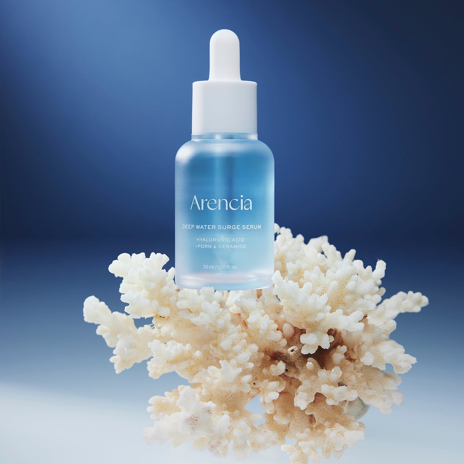 ARENCIA Deep Water Surge Serum 30ml bottle displayed on coral background