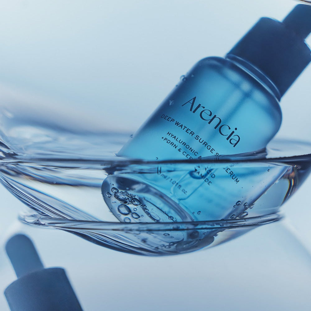 ARENCIA Deep Water Surge Serum 30ml bottle immersed in water, showcasing its hydrating properties.