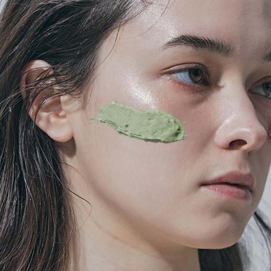 Model applying ARENCIA Fresh Green Cleanser 120g on cheek for skincare routine
