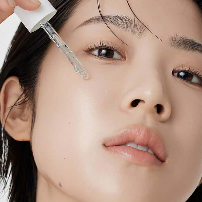 Application of ARENCIA Holy Hyssop Serum 12 30ml on woman's face for skincare routine.