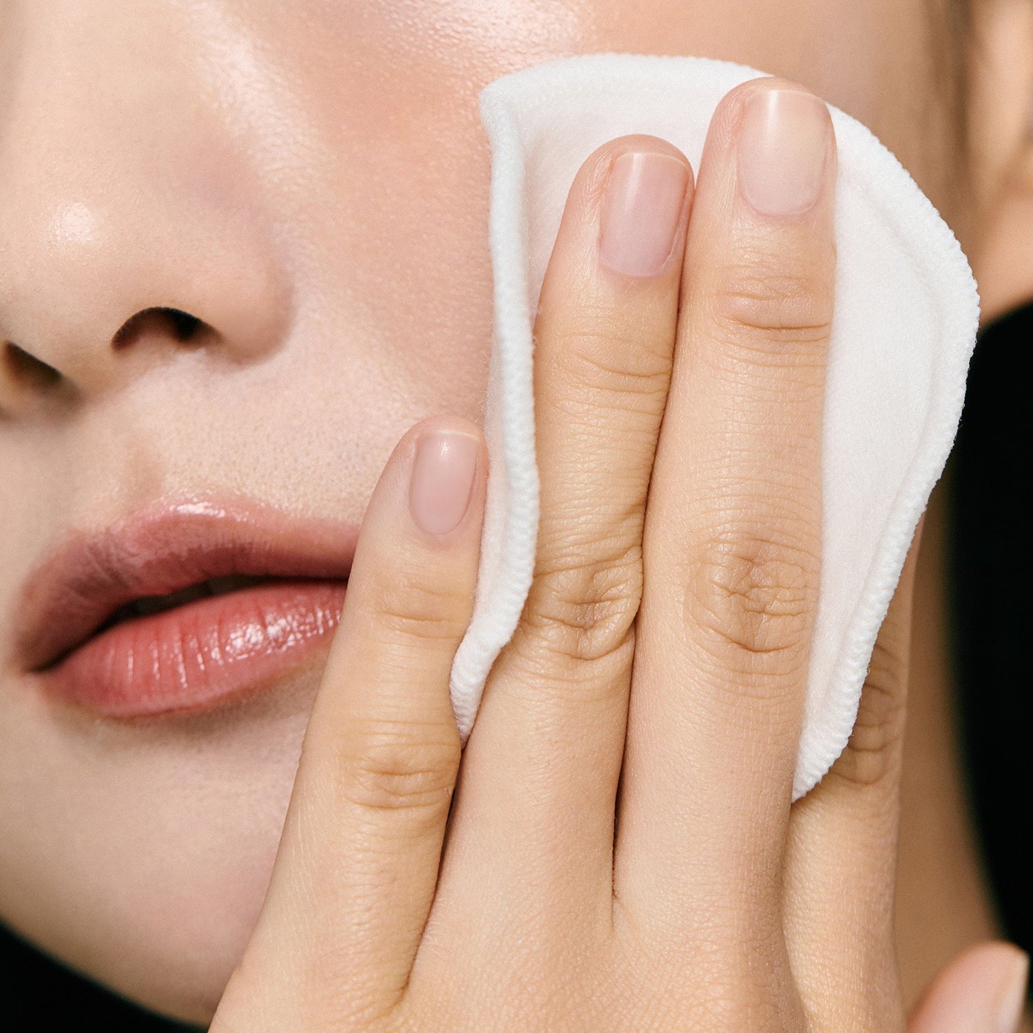 Applying AROMATICA Super Tea Tree Clarifying Toner 200ML with cotton pad on face for clear skin