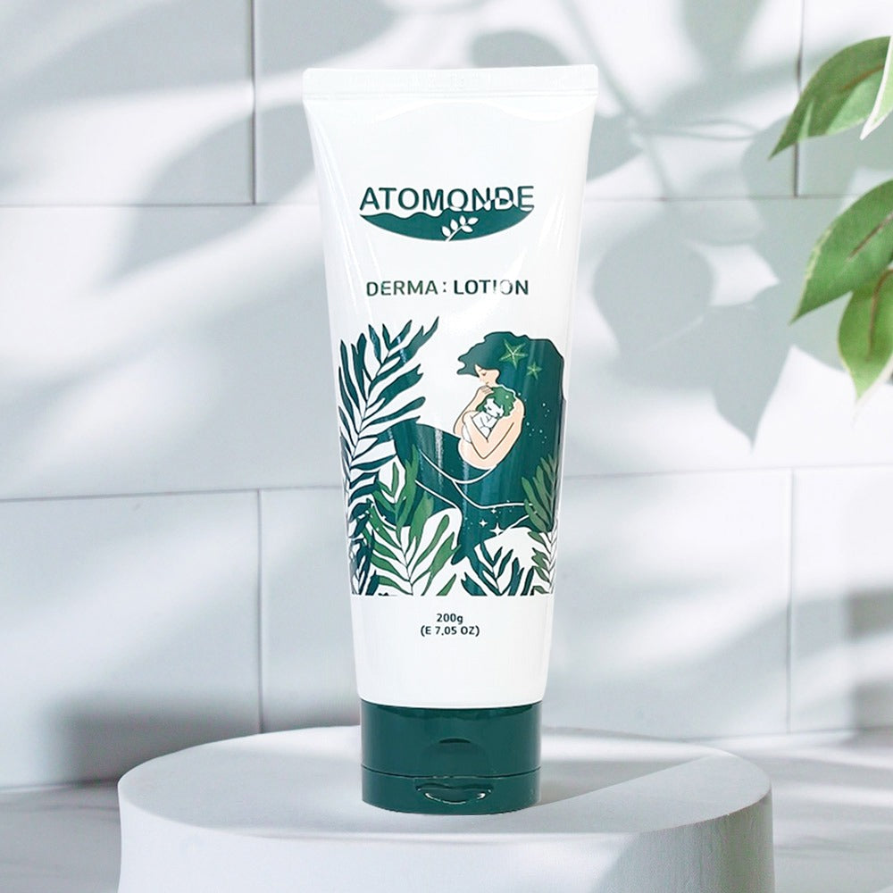 ATOMANDE Baby Derma Infant Lotion 200g bottle on a white surface with green leaf design in a bright setting.