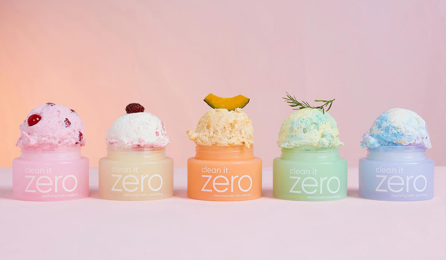Colorful display of Clean It Zero skincare products topped with decorative scoops in pastel jars