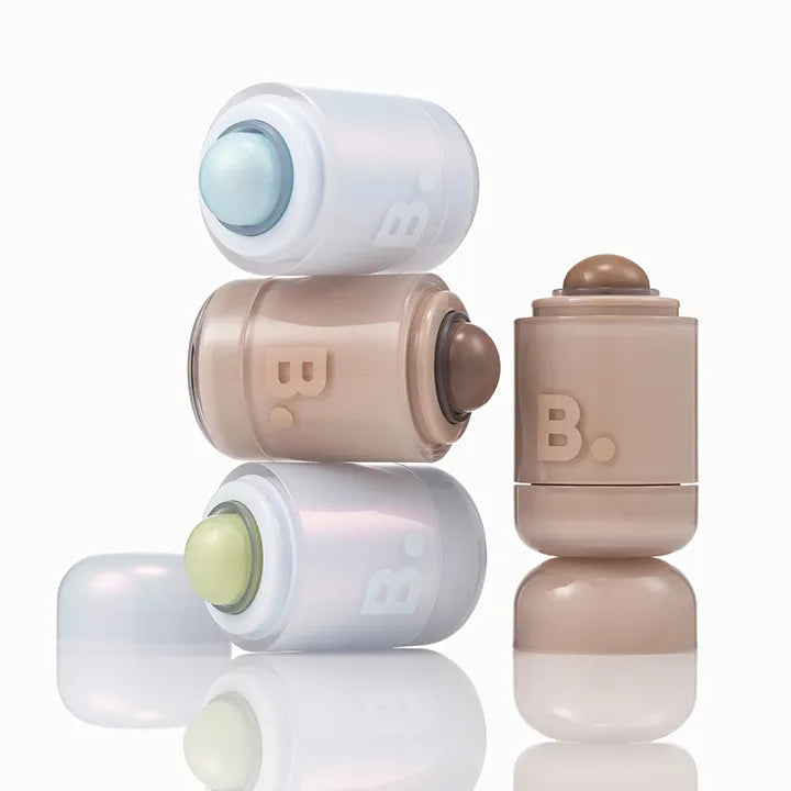 Stack of BANILA CO Romantic Blush Highlighter products in various shades with caps on a white background.