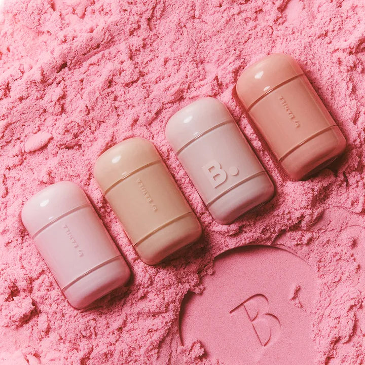 BANILA CO Romantic Blush Lip & Cheek products arranged on pink powder background.