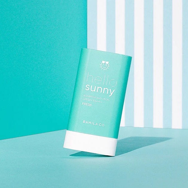 BANILACO Hello Sunny Essence Sun Stick Fresh SPF50+PA++++ on a striped turquoise background.