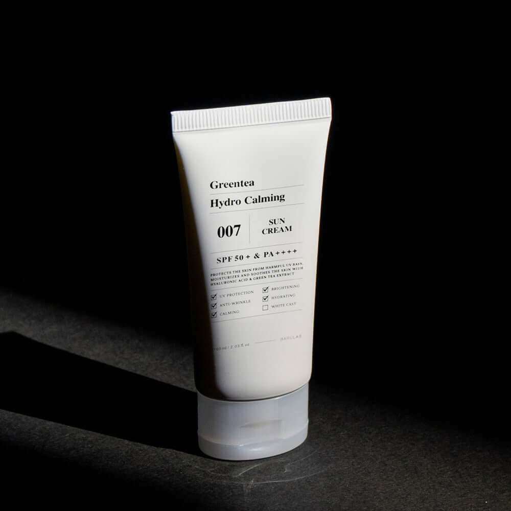 BARULAB Green Tea Hydro Calming Sun Cream in a white tube against dark background, showcasing SPF 50+ skin protection benefits.