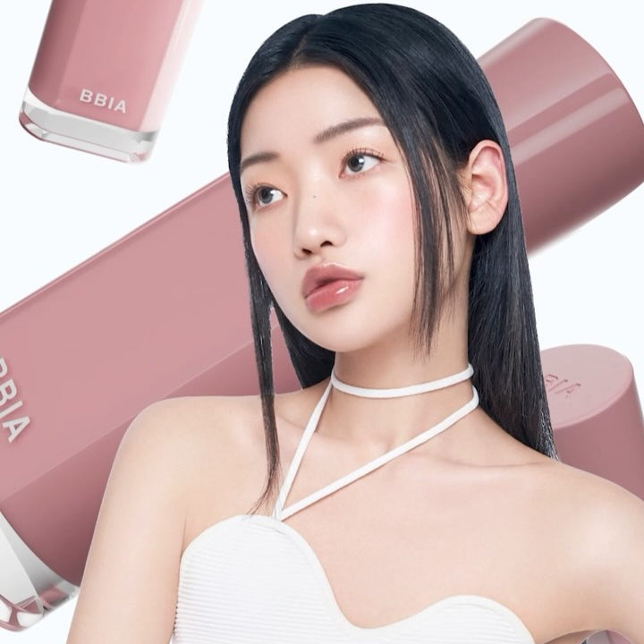 BBIA Glow Tint lipstick behind model showcasing glossy lip color.