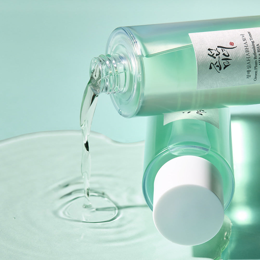 BEAUTY OF JOSEON Green Plum Refreshing Toner AHA + BHA 150ml bottle pouring on surface
