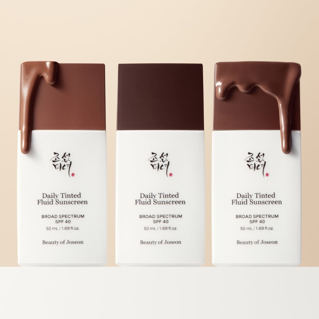 Three bottles of BEAUTY OF JOSEON Daily Tinted Fluid Sunscreen 50ml with brown tinted fluid on top, SPF 40, broad spectrum protection.