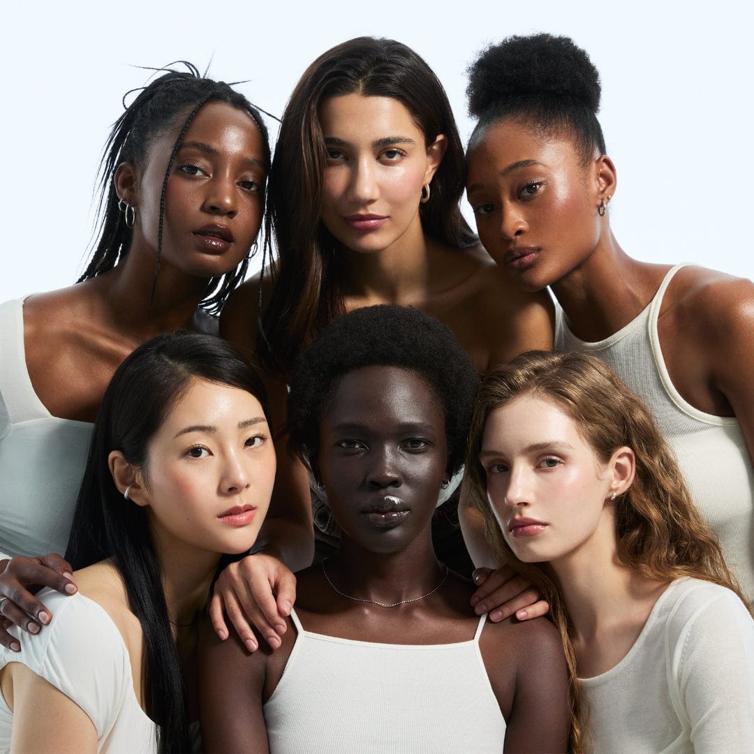 Diverse group of women posing together, showcasing beauty and diversity.