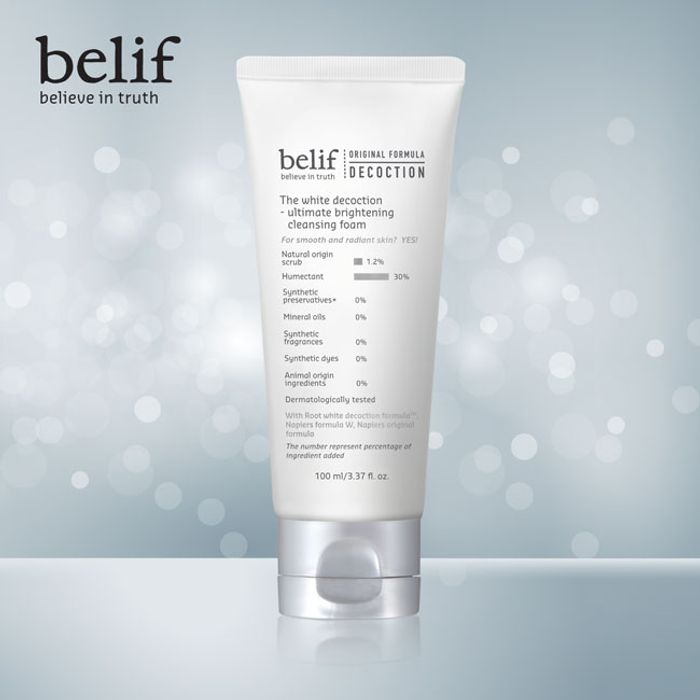 BELIF The White Decoction-Ultimate Brightening Cleansing Foam 100ml in sleek packaging on a bokeh background.