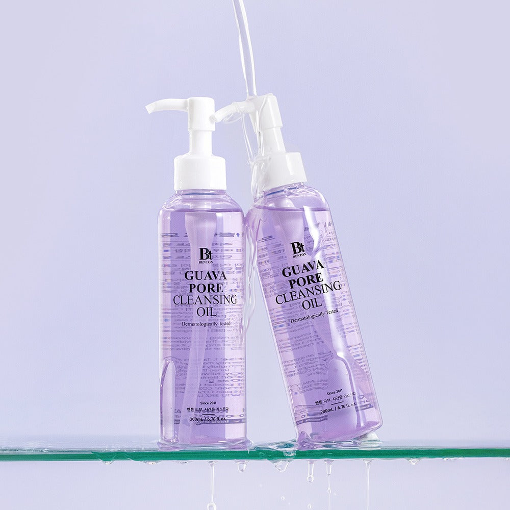Two bottles of BENTON Guava Blackhead Pore Cleansing Oil 200ml set on a glass surface.