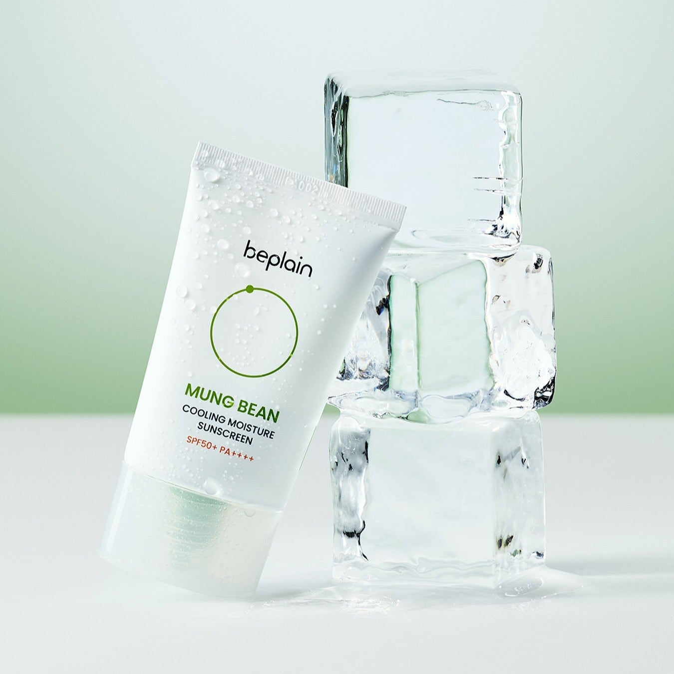 BEPLAIN Green Bean Cooling Moisture Sun Cream 50ml beside ice cubes on a green background