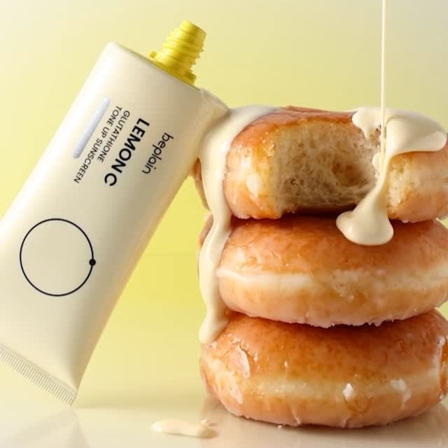 BEPLAIN Lemon Seed Glutathione Tone-up Sun Cream 50ml with glazed donuts and creamy texture.