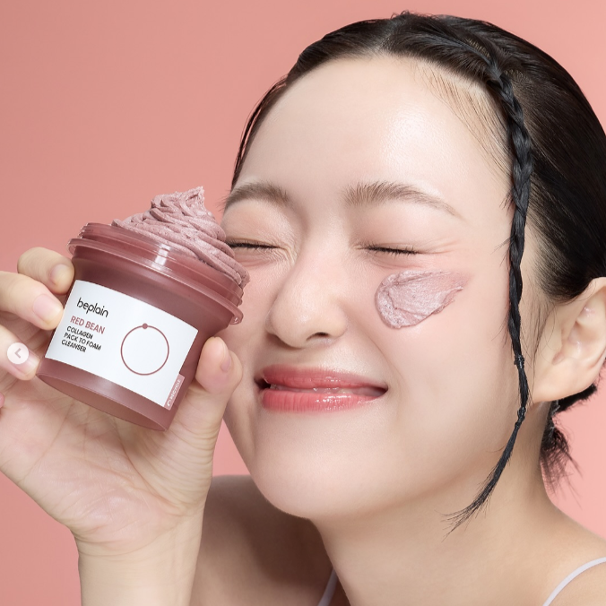 Smiling woman applying BEPLAIN Red Bean Collagen Pack-to-Foam Cleanser 100ml on face, showing skincare benefits