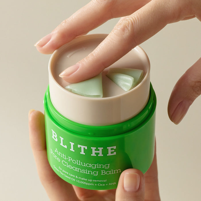 Woman using BLITHE Anti-Polluaging Pore Cleansing Balm with fingers in view.
