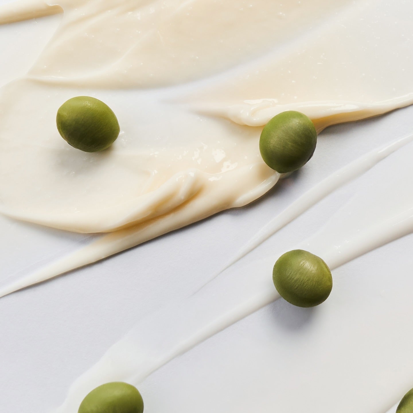 Smooth texture of BRINGGREEN Blue Bean B5-PDRN Mild Lotion 230ml with green beans on white background