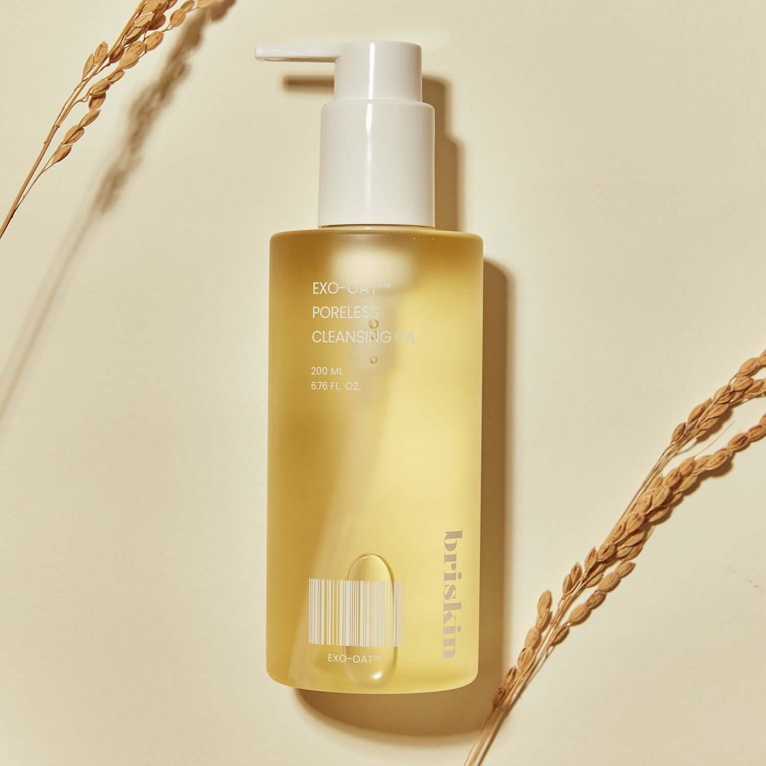 BRISKIN Exo-Oat Poreless Cleansing Oil 200ml bottle on beige background with oat sprigs