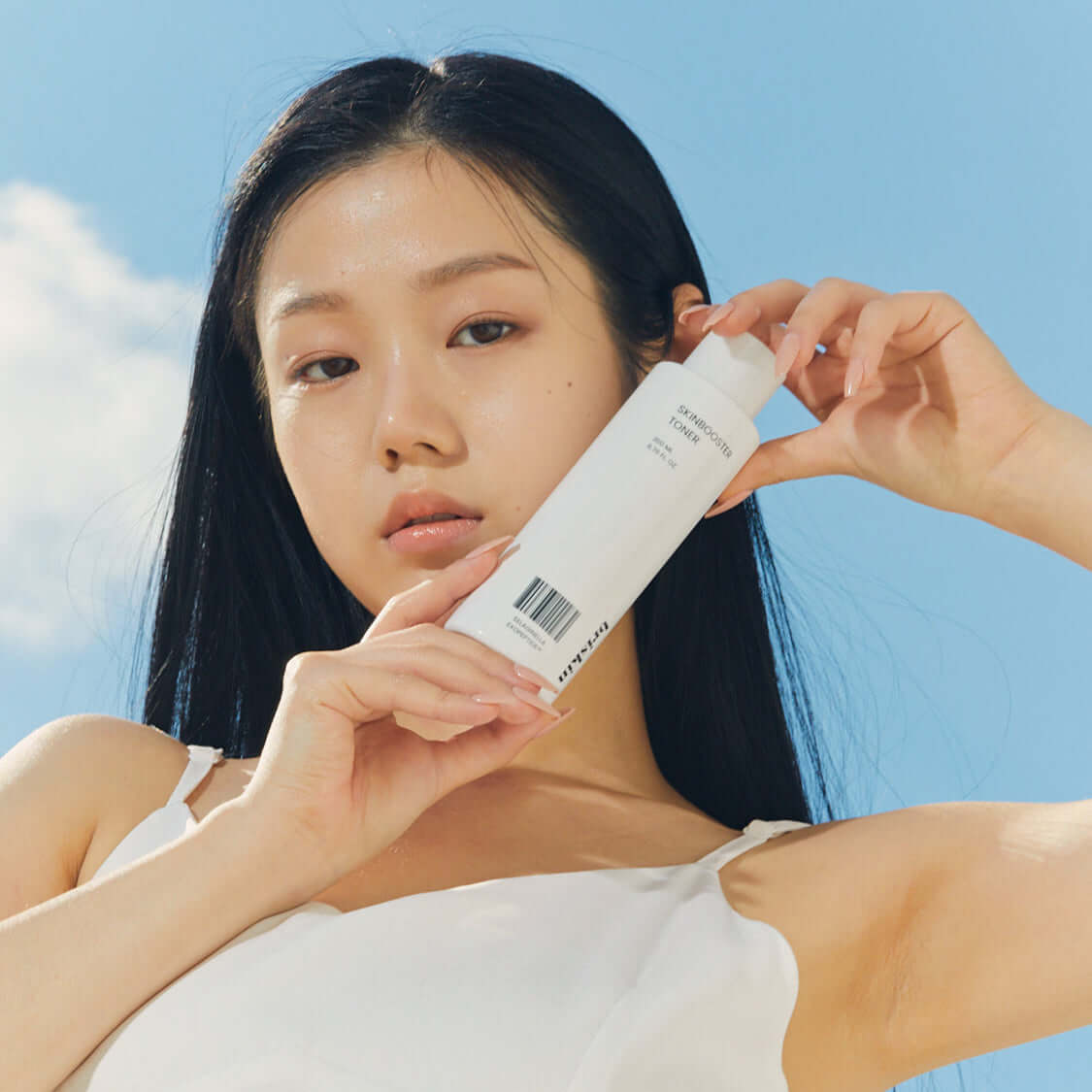 Person holding BRISKIN Selaginella Exopeptide Toner 200ml bottle outdoors