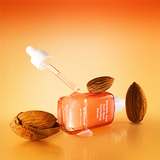 BY WISHTREND Mandelic Acid Dark Spot Correcting Serum 30ml with almonds on orange background