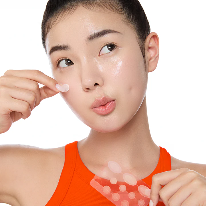 Woman applying BY WISHTREND Mandelic Acid Spot Clearing Patch 39 Patches for acne treatment on face.